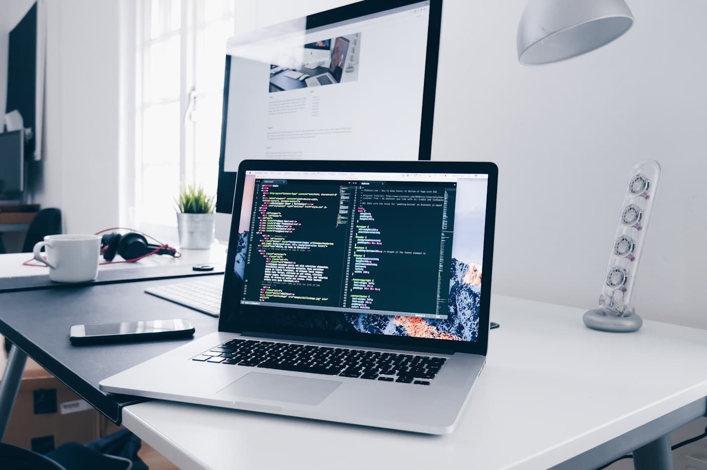 Developer working on a laptop with code on screen, representing fast AI-assisted prototyping
